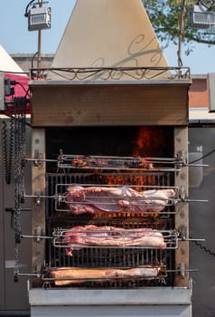 the suckling pig on the rotisserie on the open fire