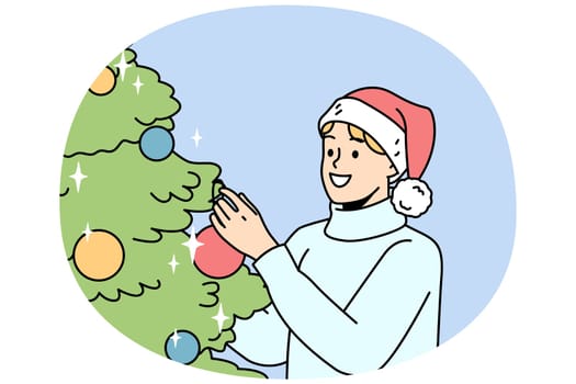 Smiling young man in Santa hat decorate Christmas tree with colorful balls. Happy guy have fun with fir-tree decoration at home celebrate New Year. Vector illustration.