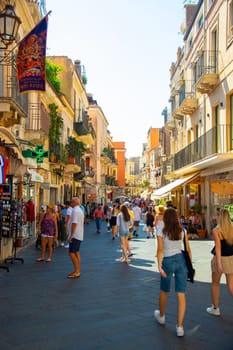 Taormina, Sicily, Italy - 28 September 2023. Tourists in the famous main street Corso umberto in Taormina. City views, facades, architecture and the most popular streets.