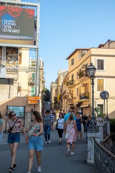 Sicily, Taormina, Italy - 28 September 2023. tourists in the Via Teatro Greco which leads directly to the ancient theatre of Taormina. City views, facades, architecture.