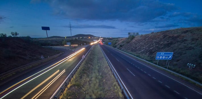 Traffic at dusk crossing the Autovia A-5, km 341. Slow motion shot