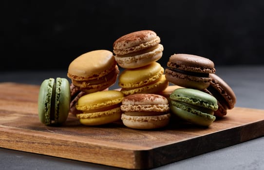 Assortment of colorful macarons on a black background