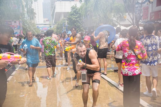 Siam Square, Bangkok, Thailand - APR 13, 2023 Songkran Festival, The short action of people joins celebrations of the Thai New Year or Songkran in Siam Square Bangkok, Thailand.