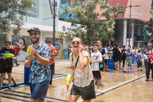 Siam Square, Bangkok, Thailand - APR 13, 2023 Songkran Festival, The short action of people joins celebrations of the Thai New Year or Songkran in Siam Square Bangkok, Thailand.