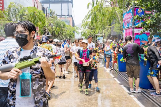 Siam Square, Bangkok, Thailand - APR 13, 2023 Songkran Festival, The short action of people joins celebrations of the Thai New Year or Songkran in Siam Square Bangkok, Thailand.