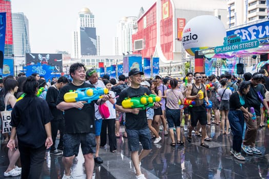 Siam Square, Bangkok, Thailand - APR 13, 2023 Songkran Festival, The short action of people joins celebrations of the Thai New Year or Songkran in Siam Square Bangkok, Thailand.
