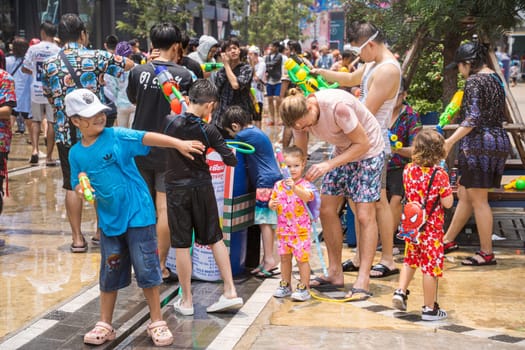 Siam Square, Bangkok, Thailand - APR 13, 2023 Songkran Festival, The short action of people joins celebrations of the Thai New Year or Songkran in Siam Square Bangkok, Thailand.