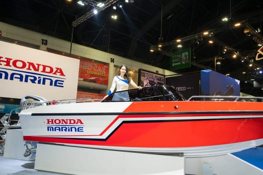 Nonthaburi, Thailand - APR 2, 2023 Unidentified model poses with a boat at The 44th Bangkok international motor show 2023 at IMPACT Arena, Muang Thong Thani, Nonthaburi, Thailand.