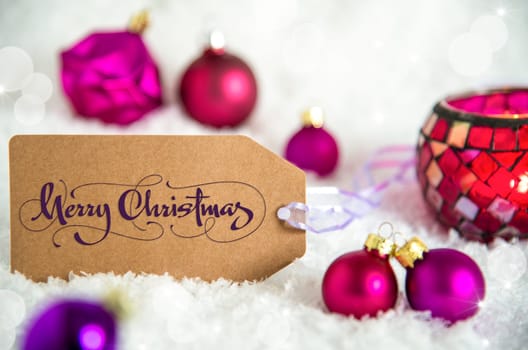 Label With Words Merry Christmas, White Snow Background With Purple Christmas Balls, Christmas And Winter Decor