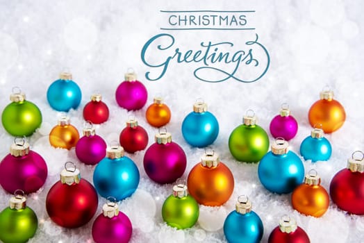 Text Christmas Greetings, On White Snow, With Many Colorful Christmas Balls, Winter Background