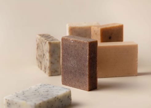 Natural herbal beige and brown handmade soap bars on light beige close up. Hygiene products for Spa and skin care. Using organic handmade sopas in everyday routine