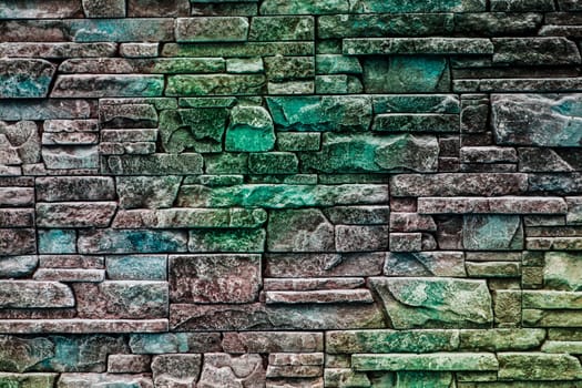 background texture of masonry decorative stones with shades of green, emerald