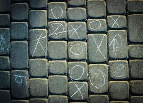 paving tile with pictures of chalk texture. cobblestone sidewalk background. abstract cobblestone background.