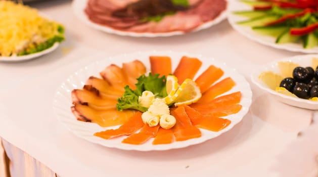 Assorted fish on a plate on festive table