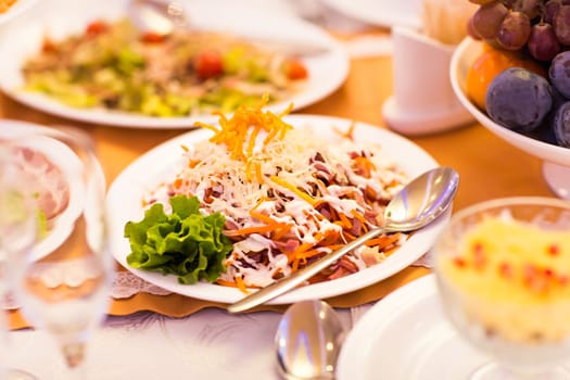 salad with cheese mushrooms and ham on festive table