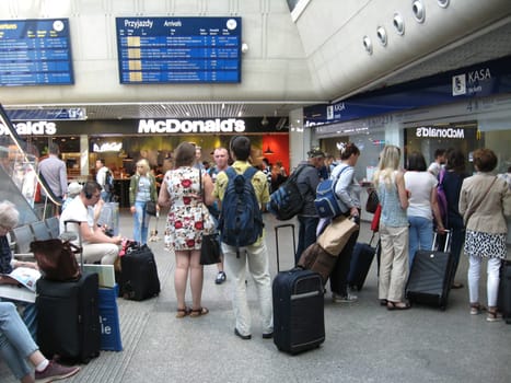 queue of passengers standing for tickets at ticket office of railway station. Travel concept. People queuing for tickets. Passengers stand for tickets at Warsaw train station