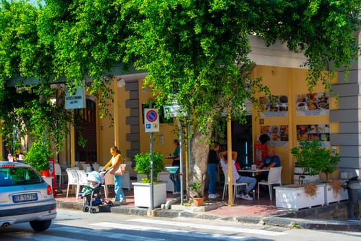 Gioiosa Marea, Sicily, Italy - 27. September 2023. Centre of the town of Gioiosa Marea with a street cafe and an ice cream bar in the province of Messina.