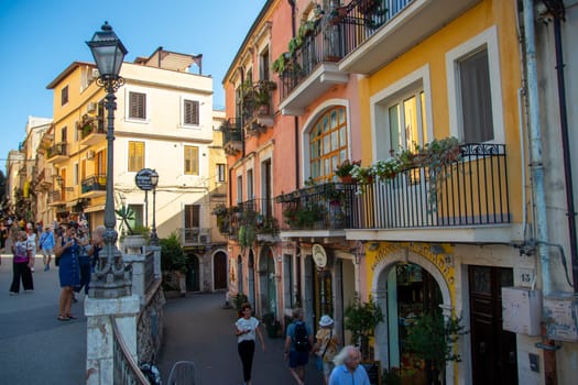 Taormina, Sicily, Italy - 28 September 2023. Tourists in the famous main street Corso umberto in Taormina. City views, facades, architecture and the most popular streets.