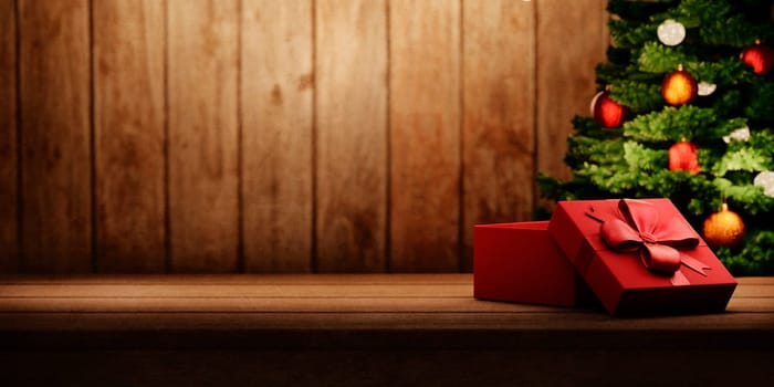 Red christmas present on vintage wooden table and christmas tree with lights. Cozy magic xmas and new year holiday scene. Open gift box on rustic wooden background with copyspace.