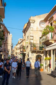 Taormina, Sicily, Italy - 28 September 2023. Tourists in the famous main street Corso umberto in Taormina. City views, facades, architecture and the most popular streets.