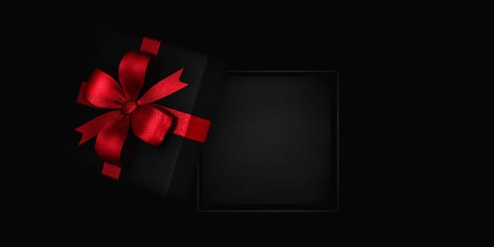 Open empty inside gift box with red ribbon from above. Black friday present background. Christmas and new year holiday surprise promo dispaly template.