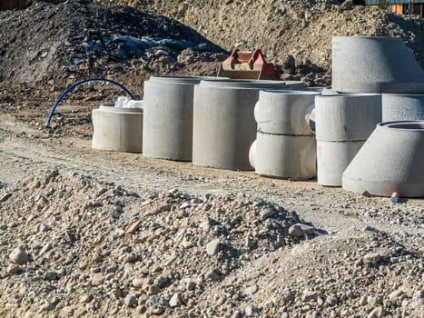 Concrete rings for building shafts on a construction site in daylight in the Somme in Bavaria.
