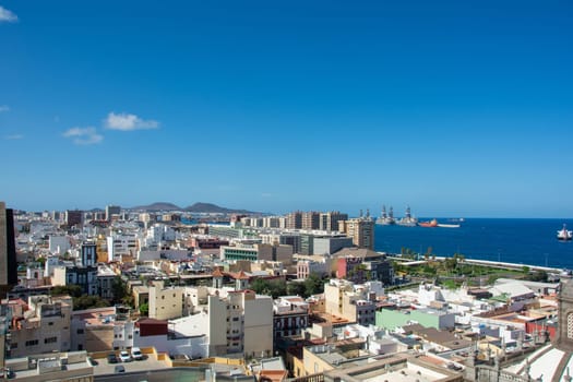 Panoramic view from above of the capital and part of the harbor in Las Palmas Gran Canaria in Spain with blue sky