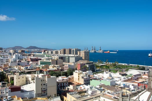 Panoramic view from above of the capital and part of the harbor in Las Palmas Gran Canaria in Spain with blue sky