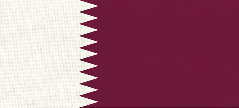 Flag of Qatar on fabric surface. Qatar national flag on texture. Fabric Texture. Asian country. Doha capital. State symbol