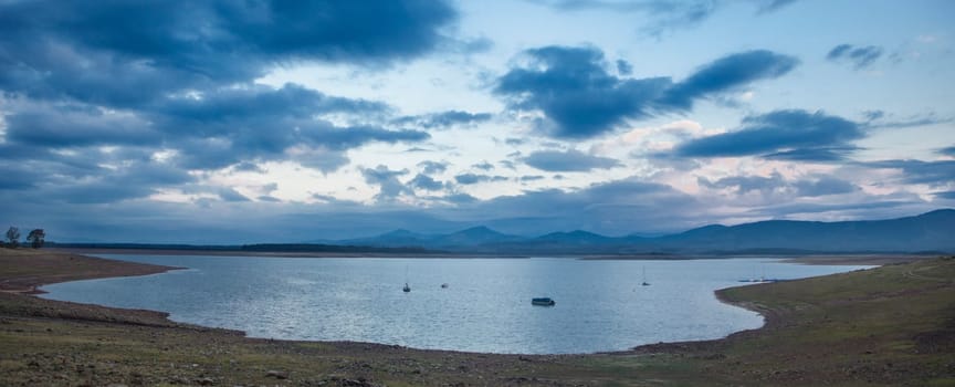 Leisure boats anchored on the shore of the Gabriel y Galan reservoir, Caceres, Spain. Active tourism at freshwaters coasts concept