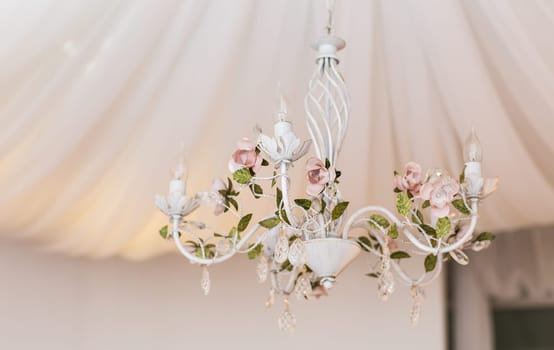 Chrystal white chandelier in the interior close-up.