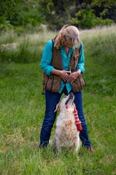Woman with her Golden Retriever doing obedience Training.