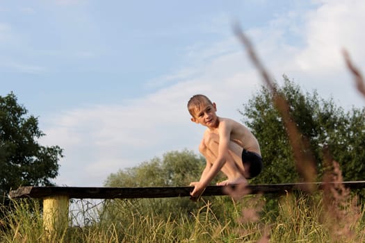 the boy is sad sitting on the bench after bathing