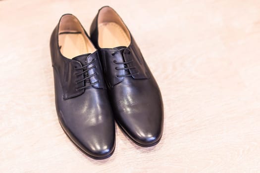 Close-up of elegant mens shoes on wooden background