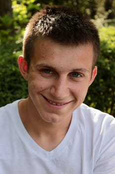 portrait of an adult smiling guy with pimples on his face