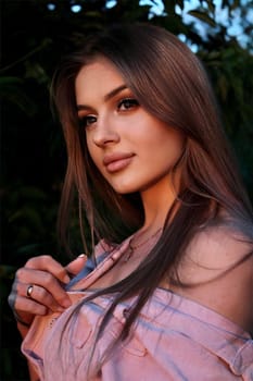 young beautiful woman taking a selfie in a field at sunset