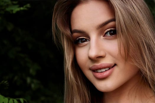 young beautiful woman taking a selfie in a field at sunset
