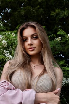young beautiful woman taking a selfie in a field at sunset