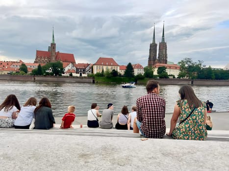 Poland, Wroclaw, July 23, summer 2024. People rest and admire the beautiful view of the Polish city of Wroclaw, fairy-tale houses and the river