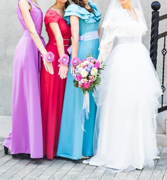 Bride with bridesmaids on the park on the wedding day