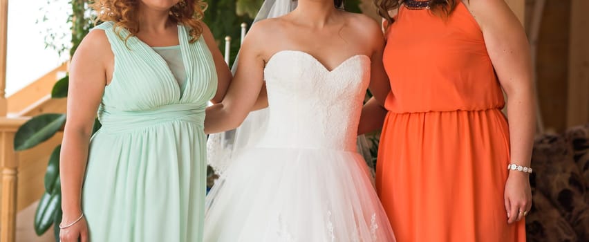 Bride with bridesmaids indoors on the wedding day