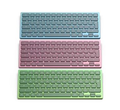Row with three wireless computer keyboards with different colors on white background