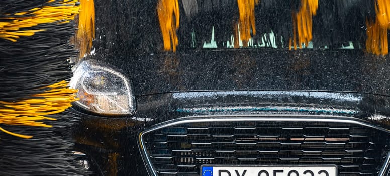A vehicle in an automatic car wash.