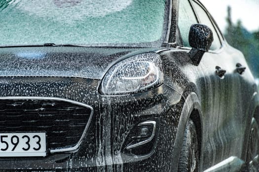 A vehicle in an automatic car wash.