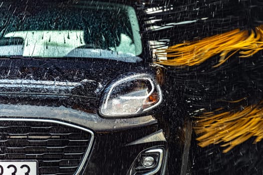 A vehicle in an automatic car wash.