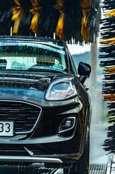 A vehicle in an automatic car wash.