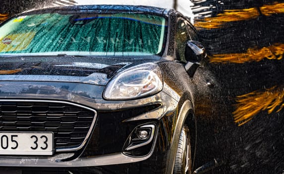 A vehicle in an automatic car wash.