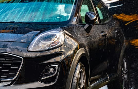 A vehicle in an automatic car wash.