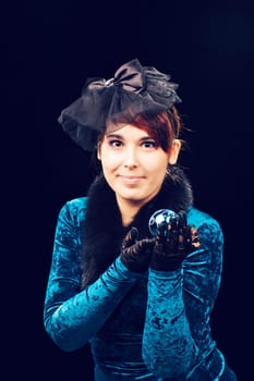 Portrait of happy young woman holding christmas ball.