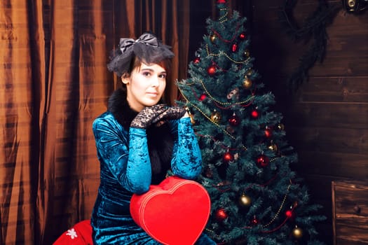 Portrait of the Beautiful woman at the Christmas tree.
